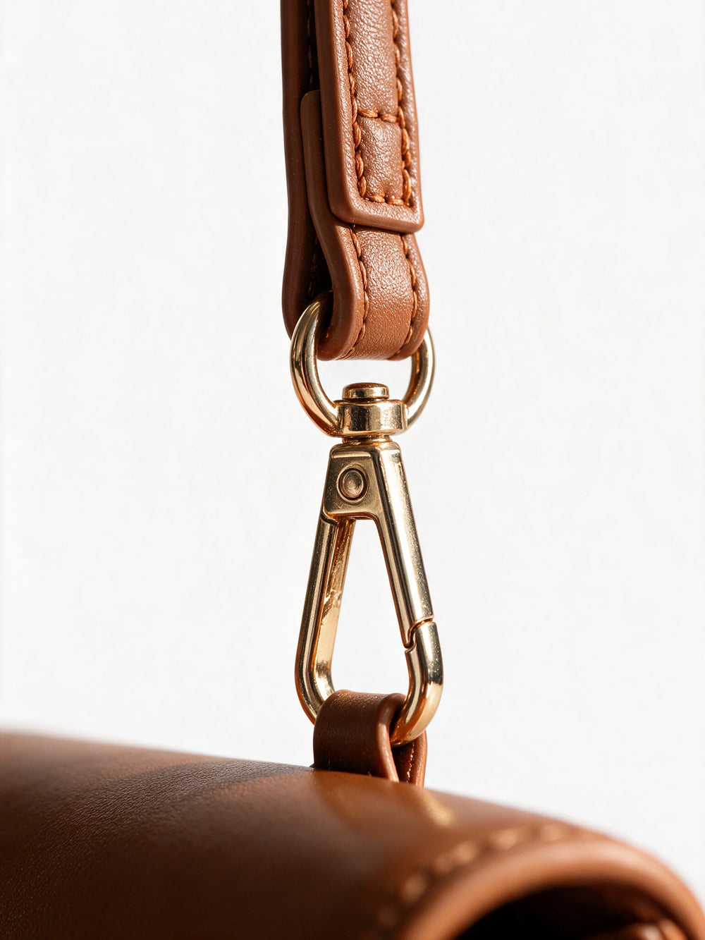Gold clasp and wrist strap detail of the Sentir travel pouch